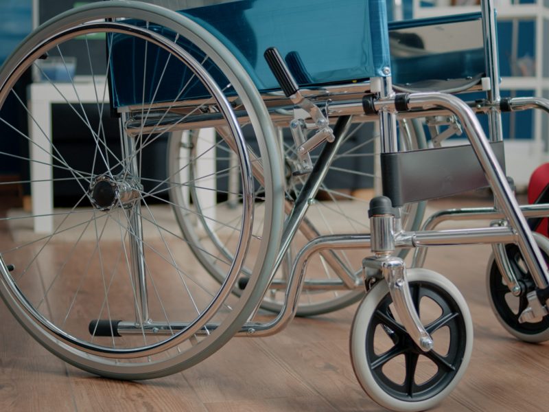 Close up of wheelchair for physical support in nursing home used by disabled people. Object of transportation for medical assistance and rehabilitation. Facility for recovery and treatment