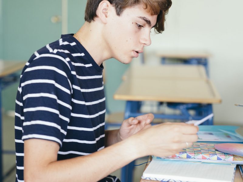 focused-boy-doing-his-homeworks-class
